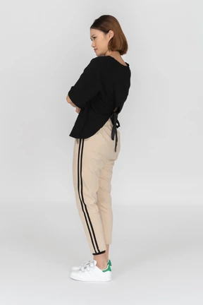 Three quarters back view of young woman