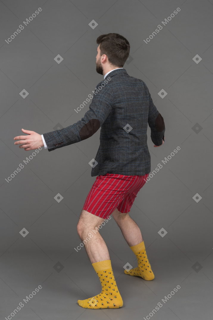 Man in red underwear and grey jacket looking aside