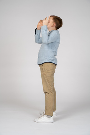 Young boy looking up and gesturing