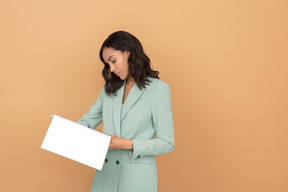 Attractive young woman reading a file