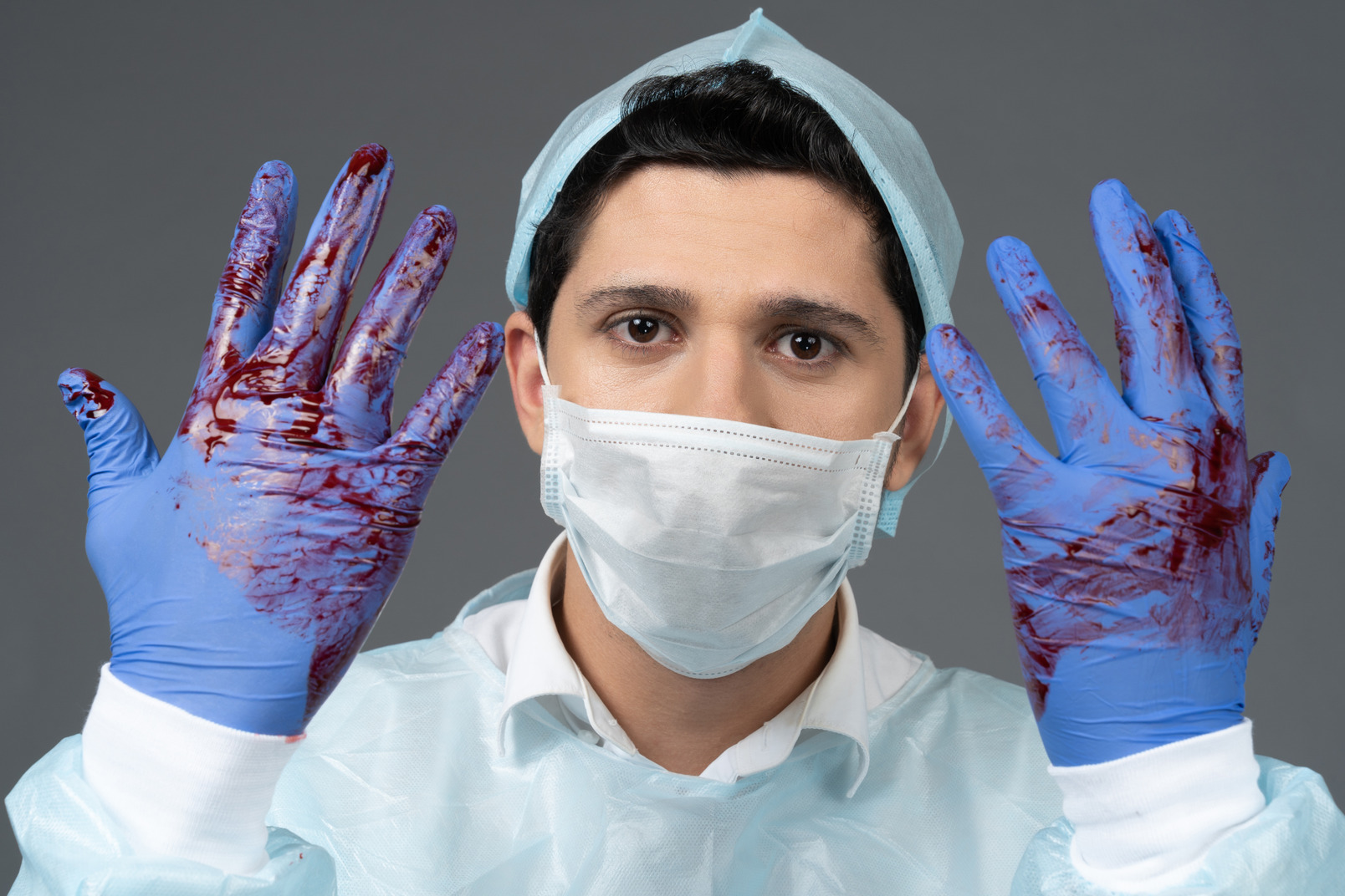 Doctor with gloves covered in blood