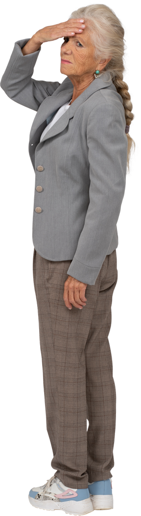 Side view of an old lady in suit touching her forehead