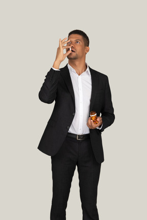 African american man in black suit taking pills