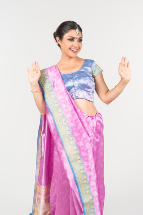 Happy looking young indian woman in purple sari