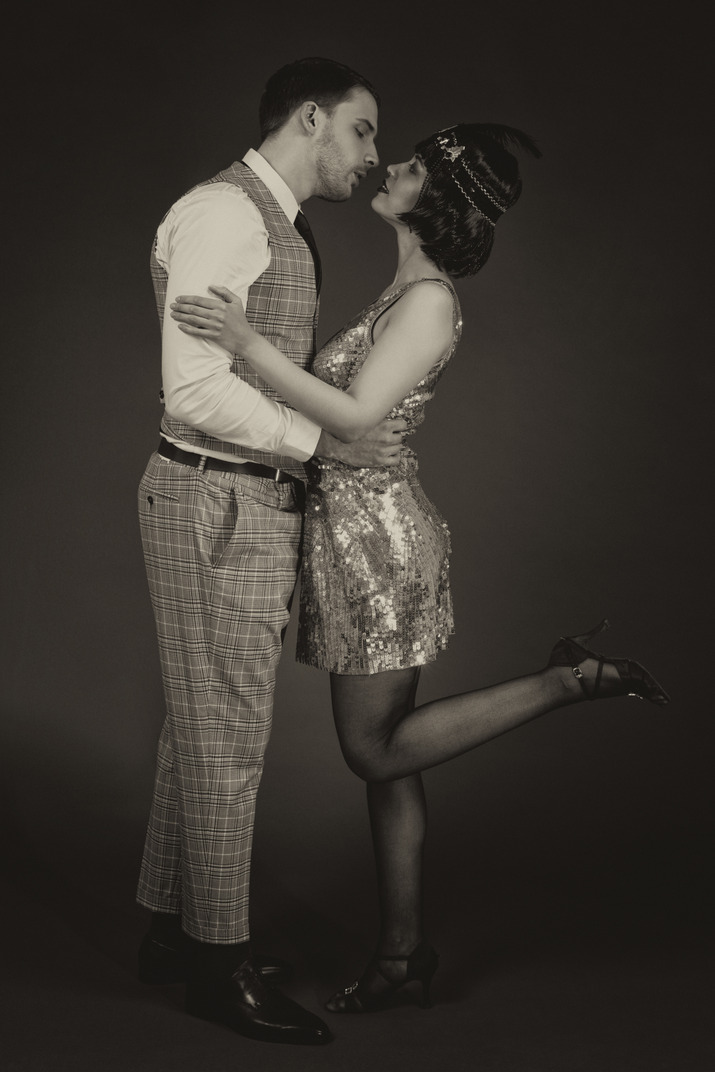 Retro-styled couple kissing in the dark