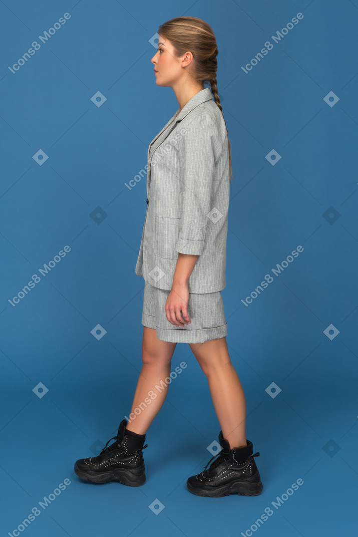 Young woman standing sideways to camera