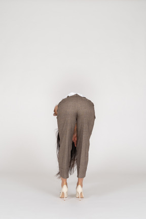 Back view of a young lady in breeches and t-shirt bending down
