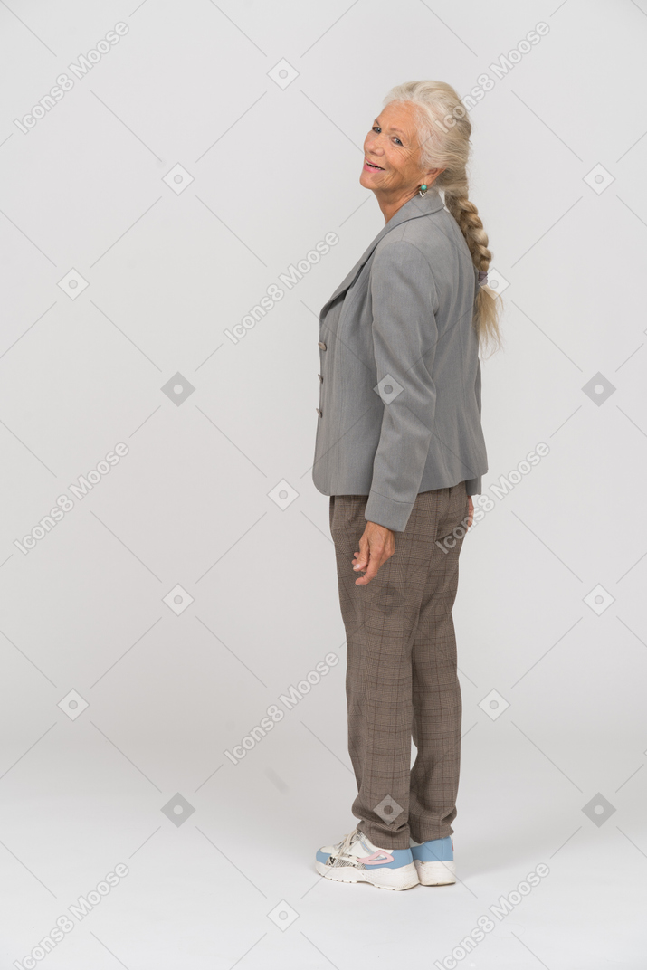 Rear view of a happy old woman in suit
