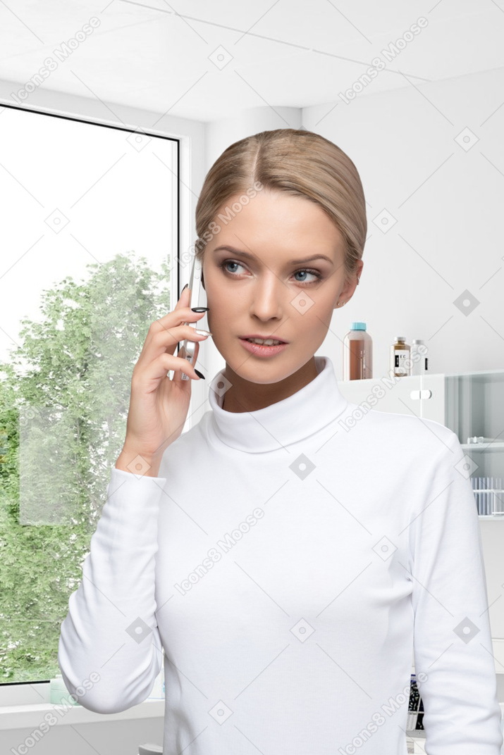 A young woman talking on the phone in a medical office
