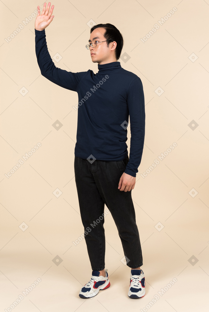 Young asian man waving