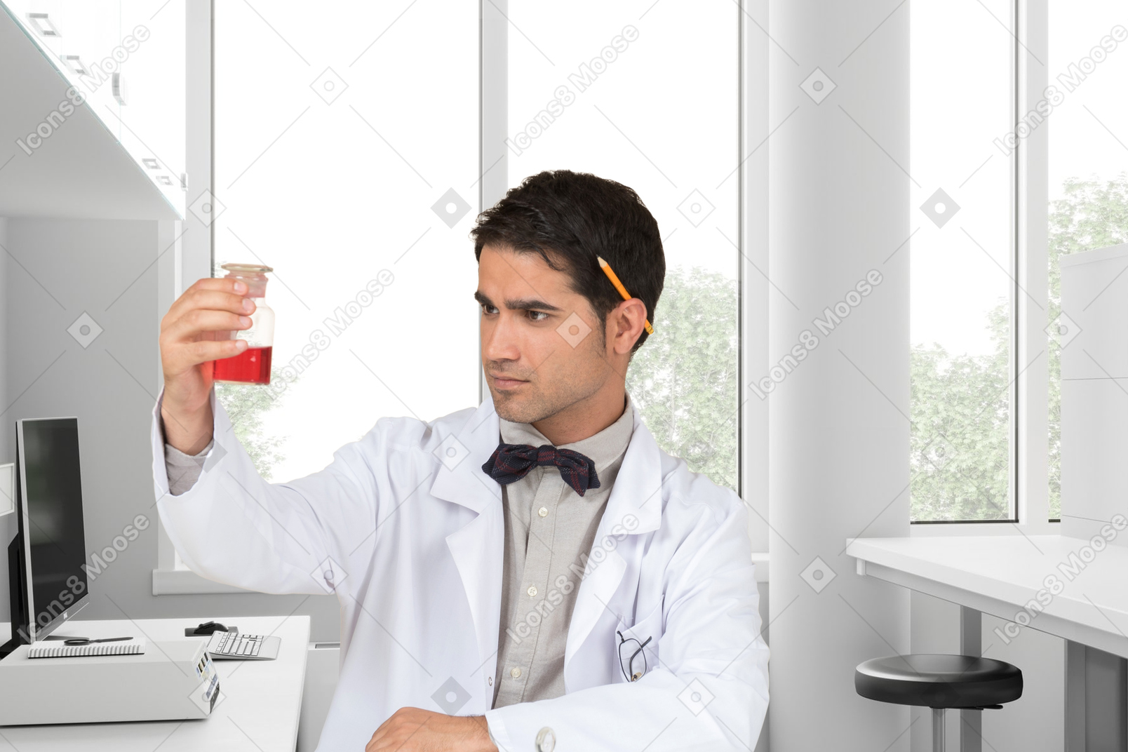 Young scientist holding a test tube with something red in his hand