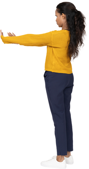 Side view of a girl in casual clothes showing stop gesture