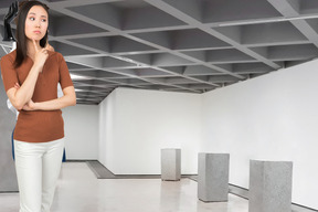 A woman standing in an empty gallery