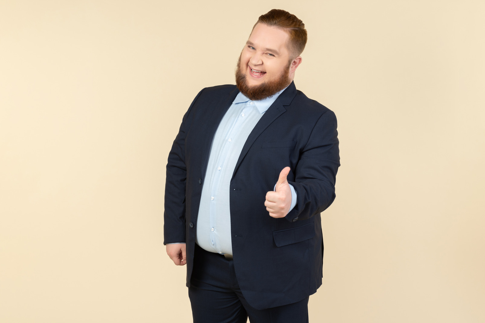 Young overweight man in suit showing thumb up