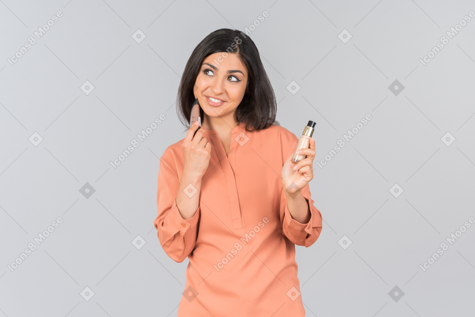 Indian woman pointing at lip balms she's holding