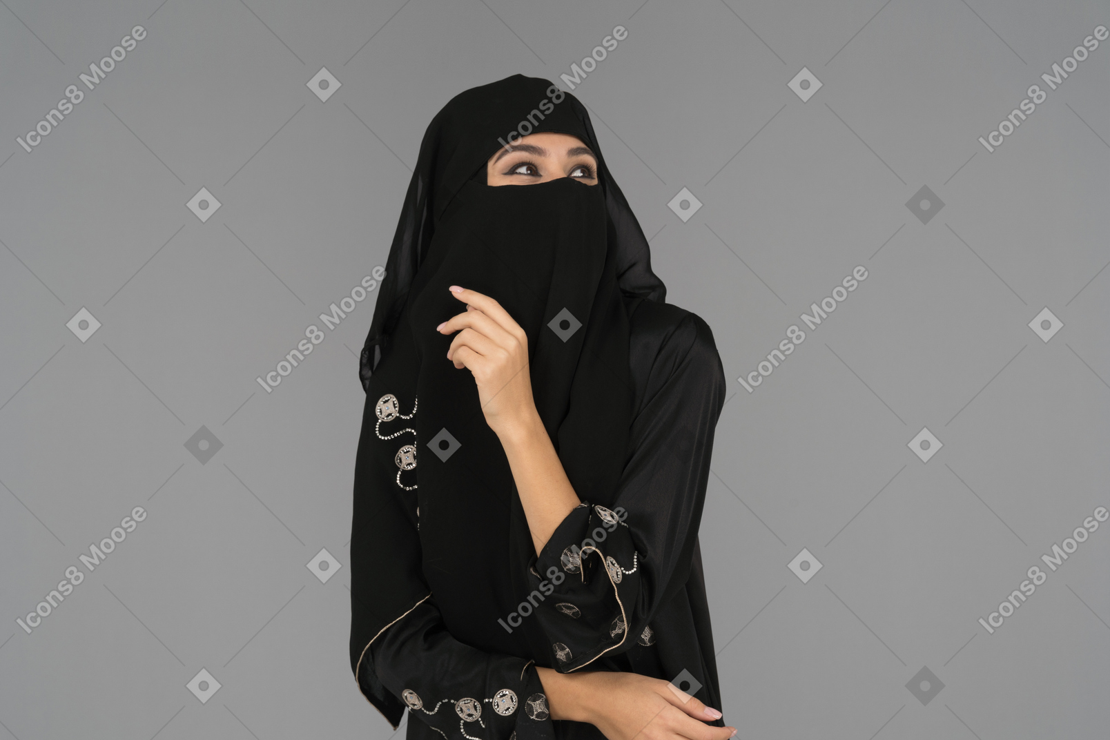 A covered muslim woman looking up