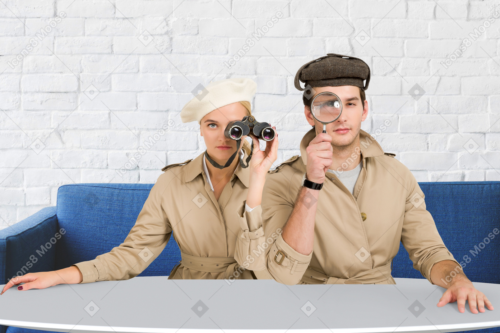 Man and woman sitting at table with binoculars and magnifying glass