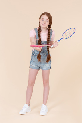 Teenage girl handling tennis racket she's holding