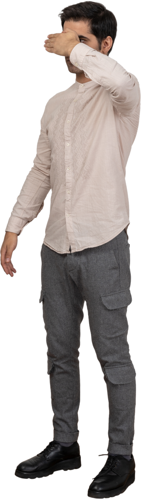 Man in shirt standing with his eyes closed