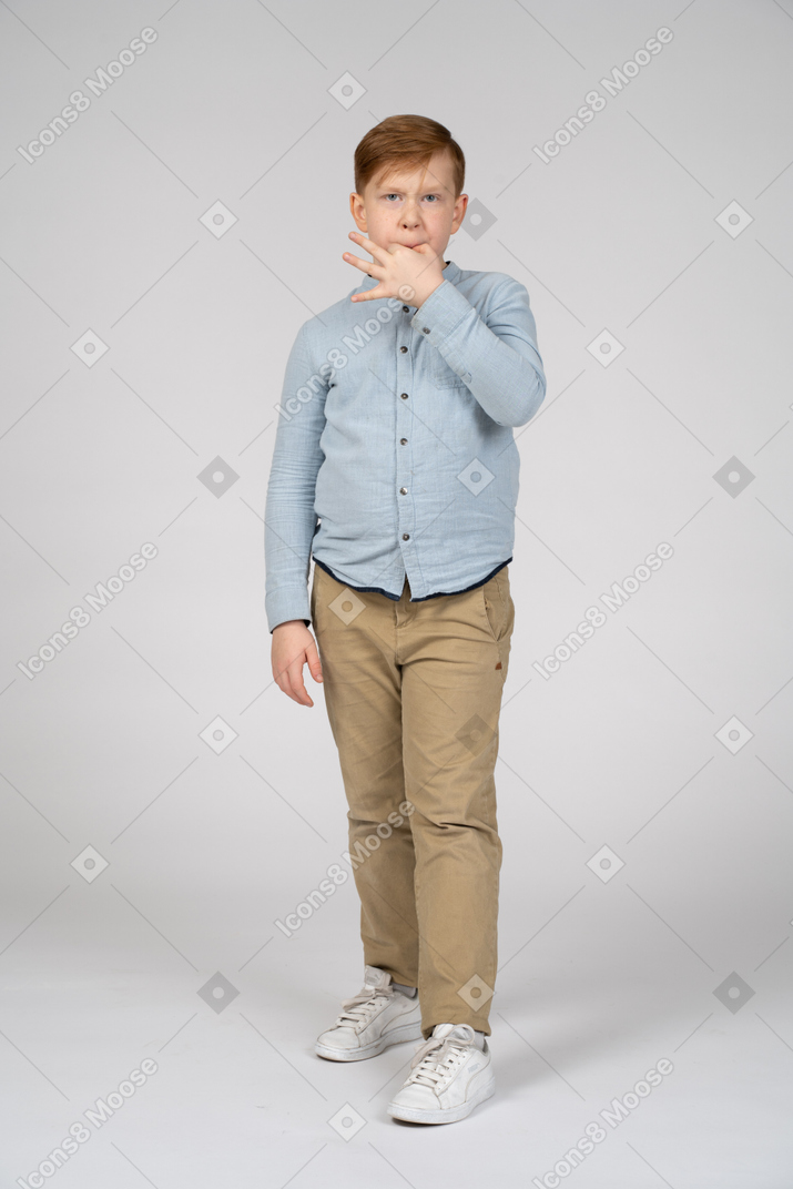 Boy looking at camera and whistling