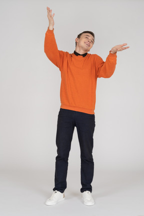 Young man in orange sweatshirt standing