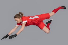 A female goalkeeper in the air