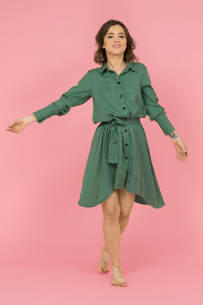 Cheerful brunette girl in green dress