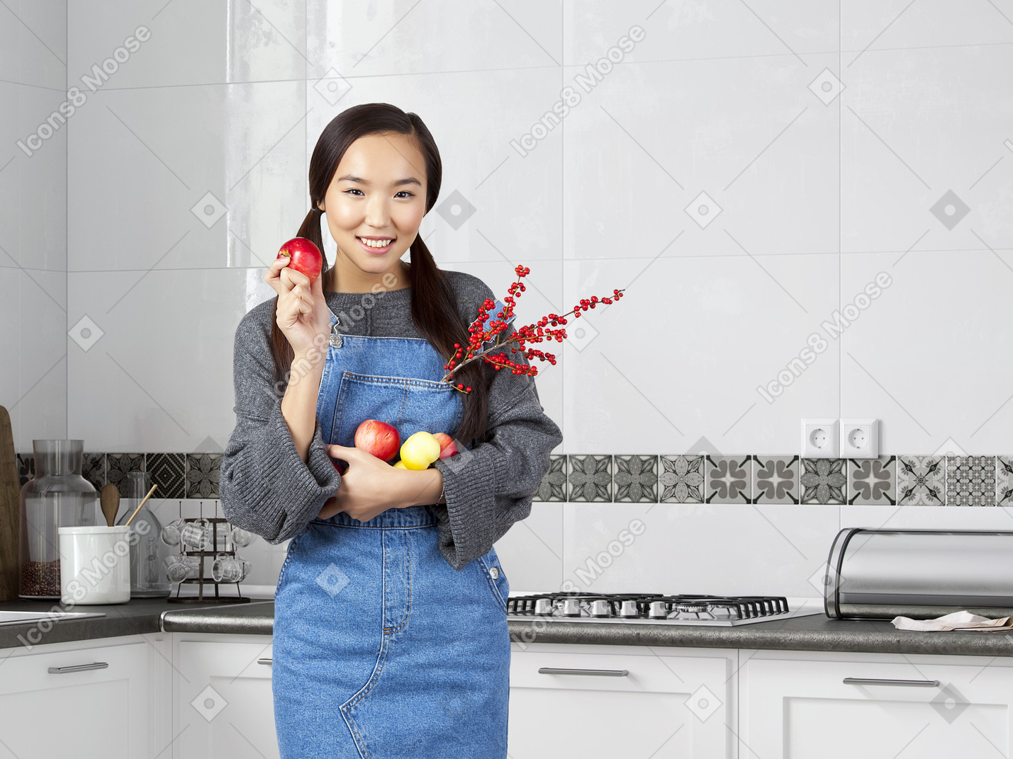 Happy young man eating apple in the kitchen