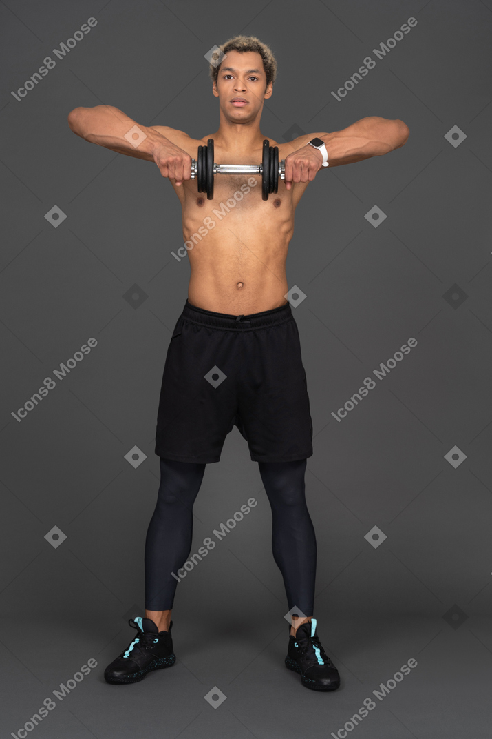Front view of a shirtless afro man lifting the dumbbell