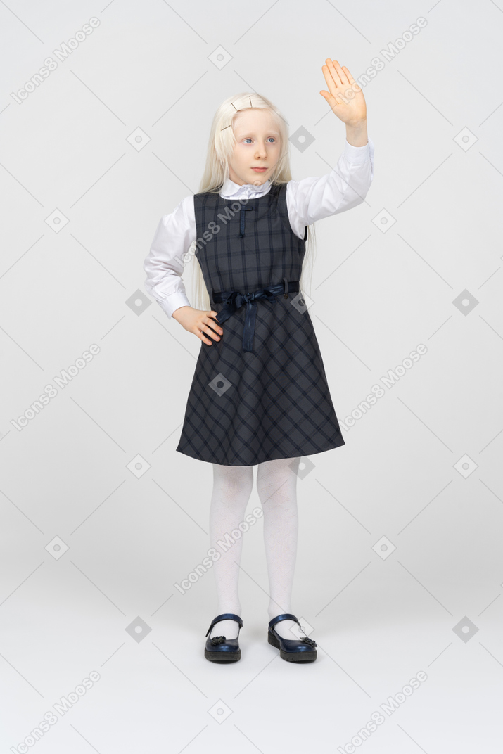 Schoolgirl holding her hand up