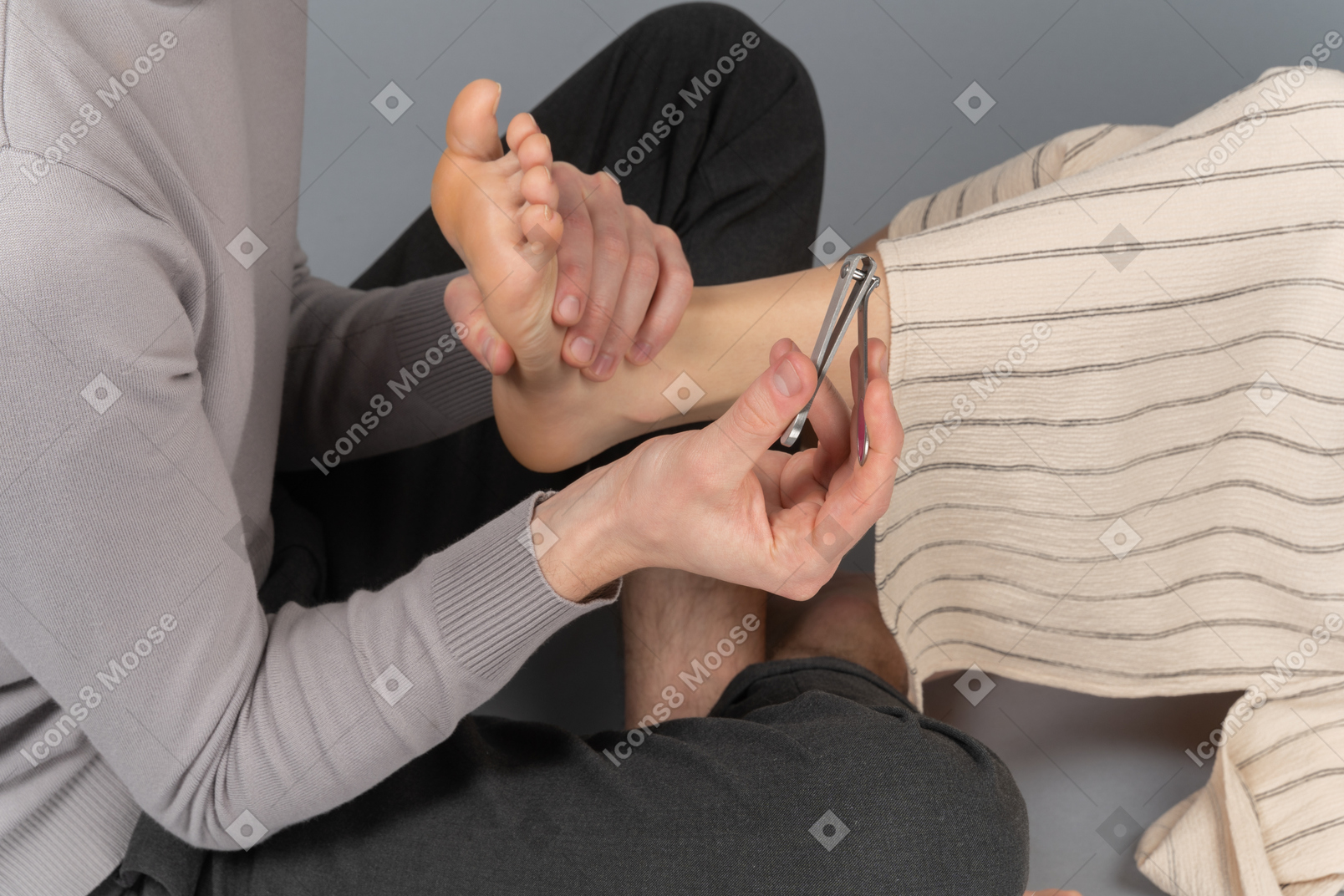 A man is about to cut woman`s toenails