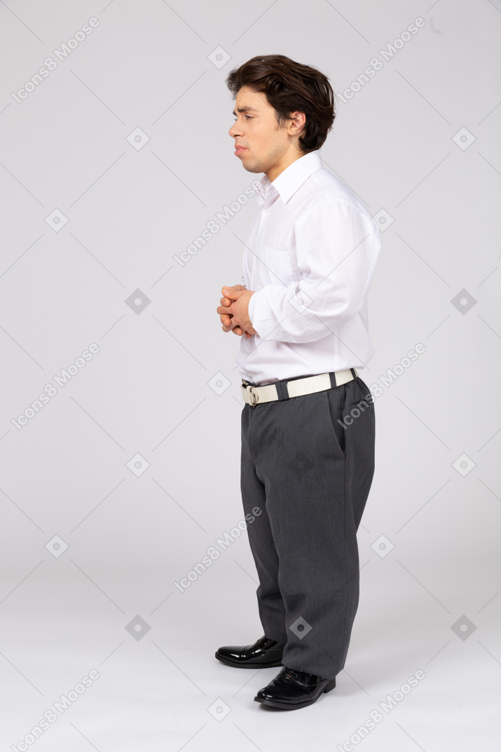 Unhappy man standing with his hands folded