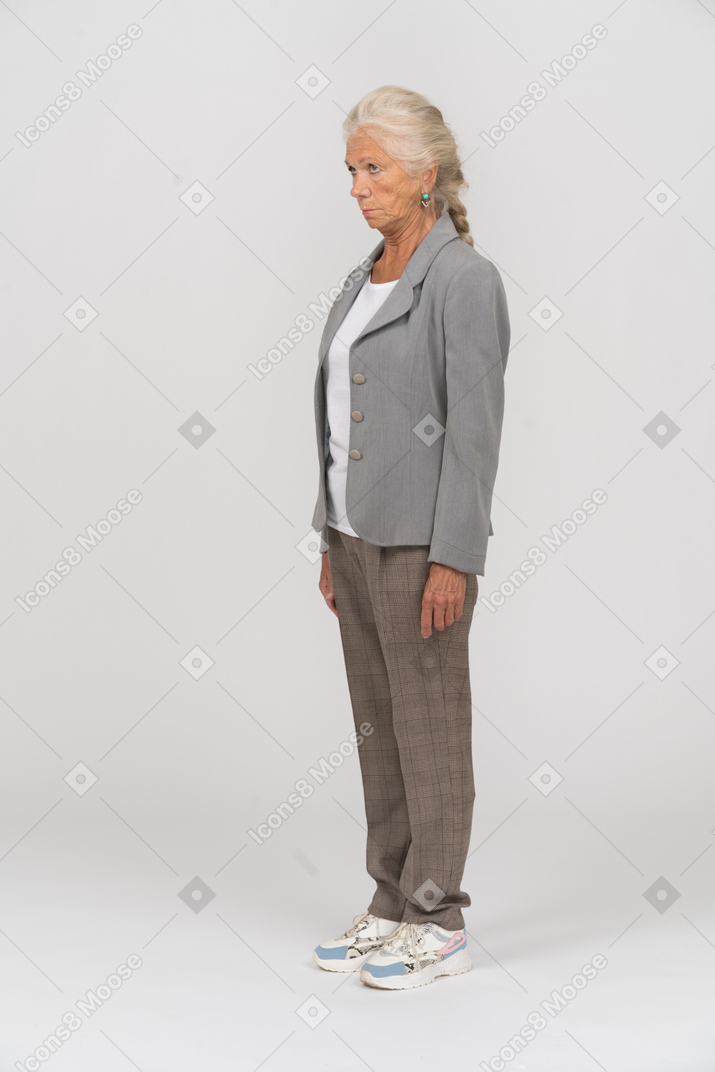 Old woman in suit standing in profile