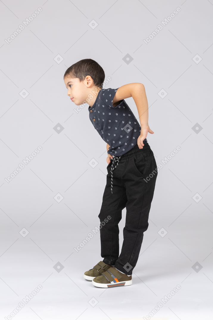 Side view of a cute boy exercising