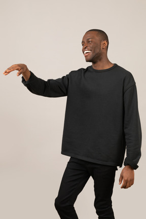 Young man laughing and raising hand