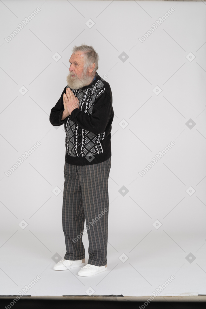 Senior man praying with folded hands