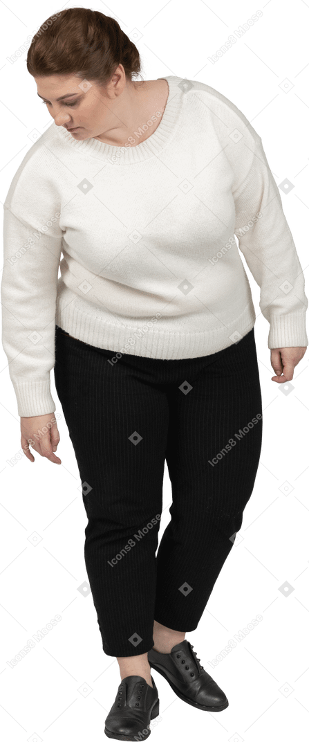 Front view of a plump woman in casual clothes looking down