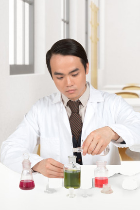 Scientist conducting experiment with test tubes