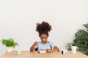 Good looking cute girl doing science at the table