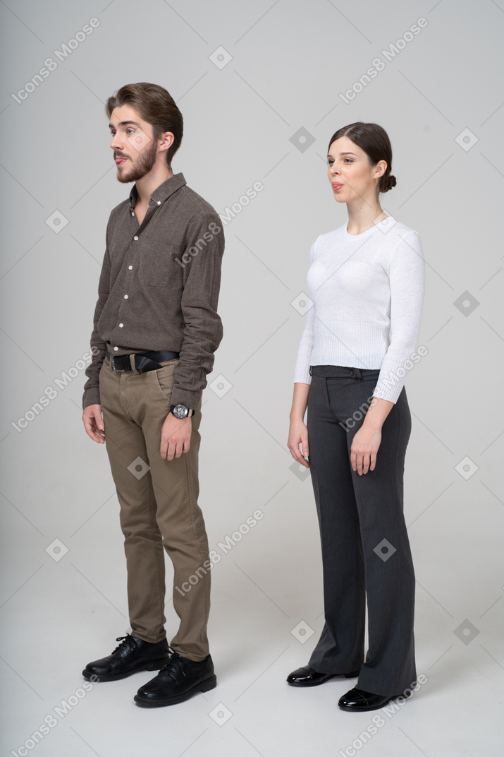 Three-quarter view of a young couple in office clothing showing small tongue