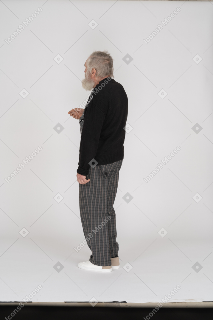 Back view of old man standing with raised hand