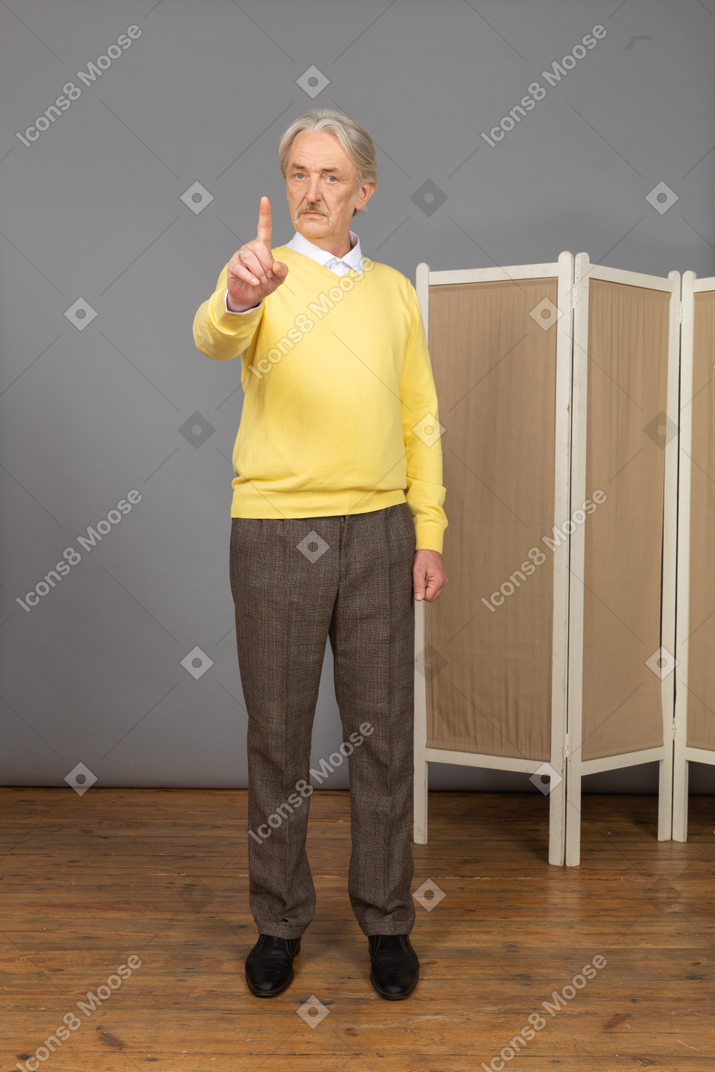 Front view of an old man pointing finger