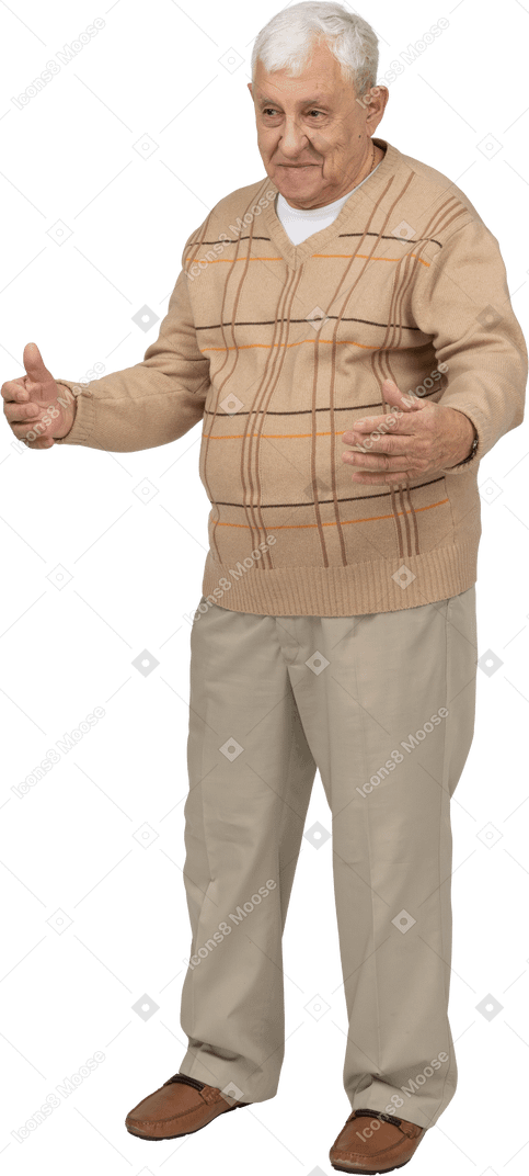 Front view of an old man in casual clothes standing with outstretched arms