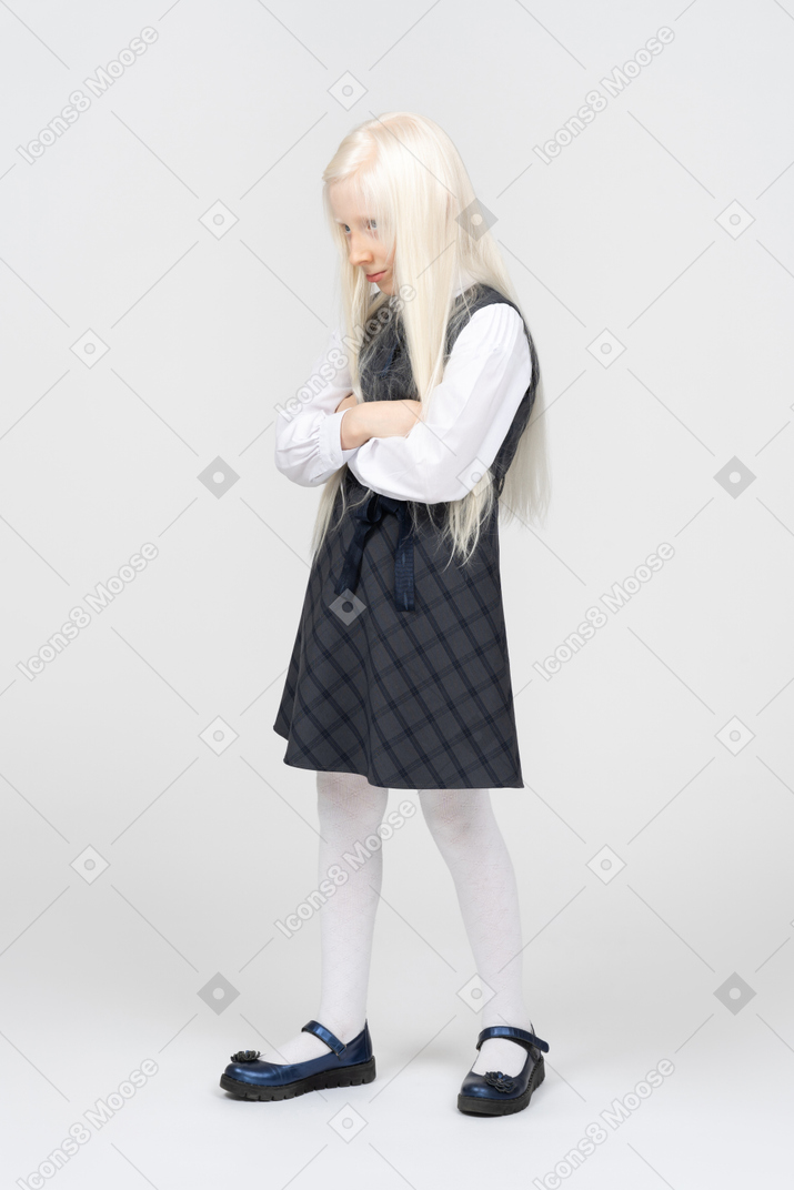 Schoolgirl pouting with arms crossed