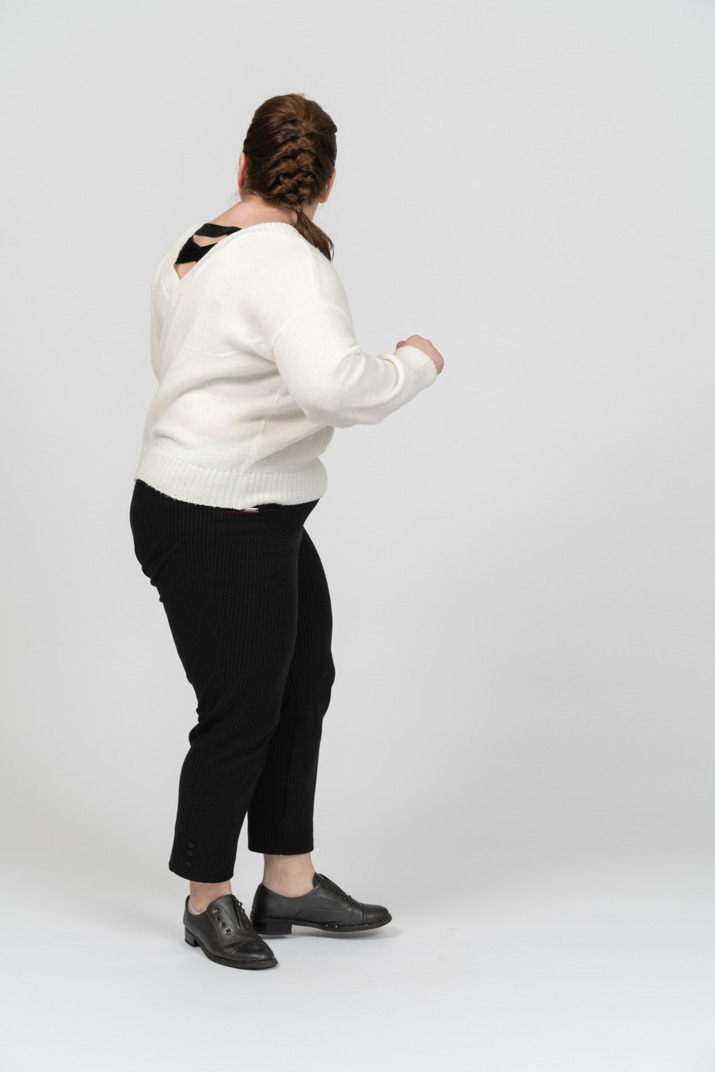 Plump woman in casual clothes moving