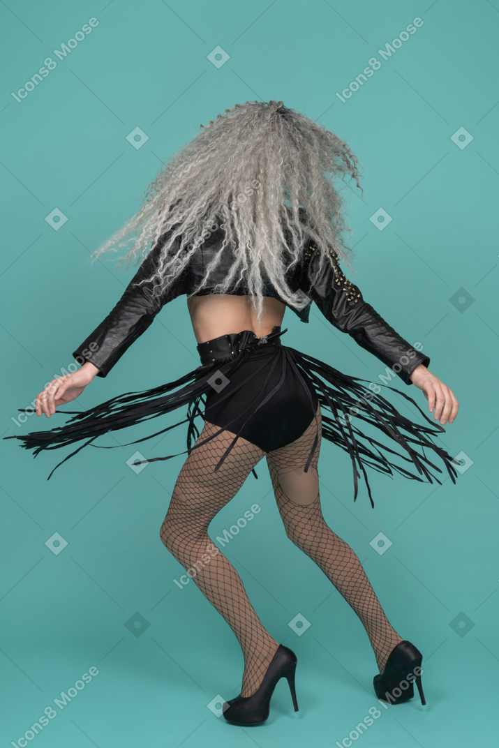 Back view of a drag queen spinning around