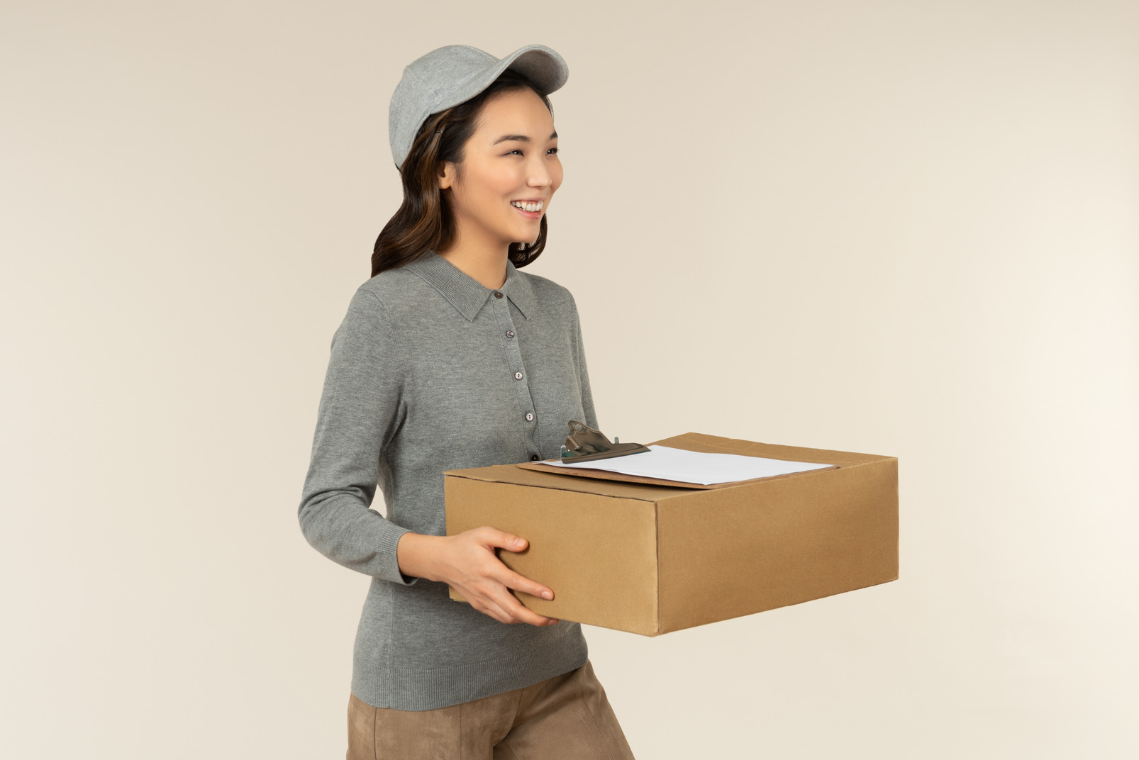Young asian delivery girl holding boxes with folder on it