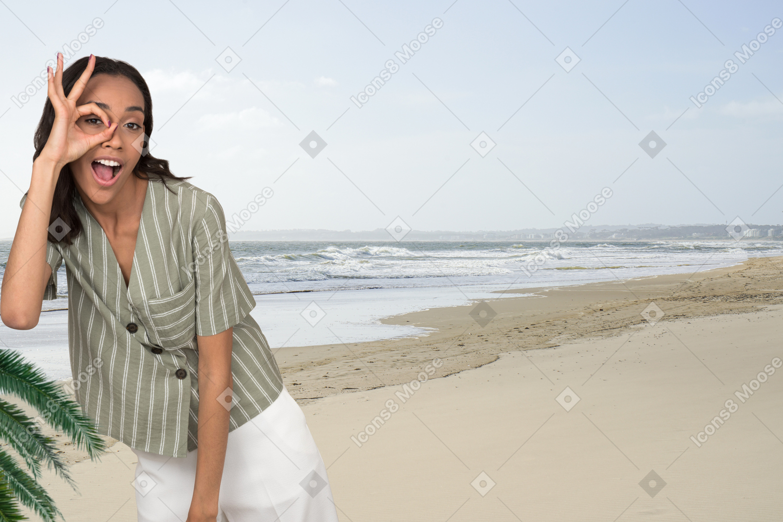 Woman looking through imaginary binoculars on the beach