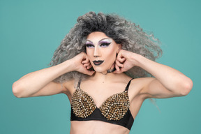 Drag queen adjusting choker around neck