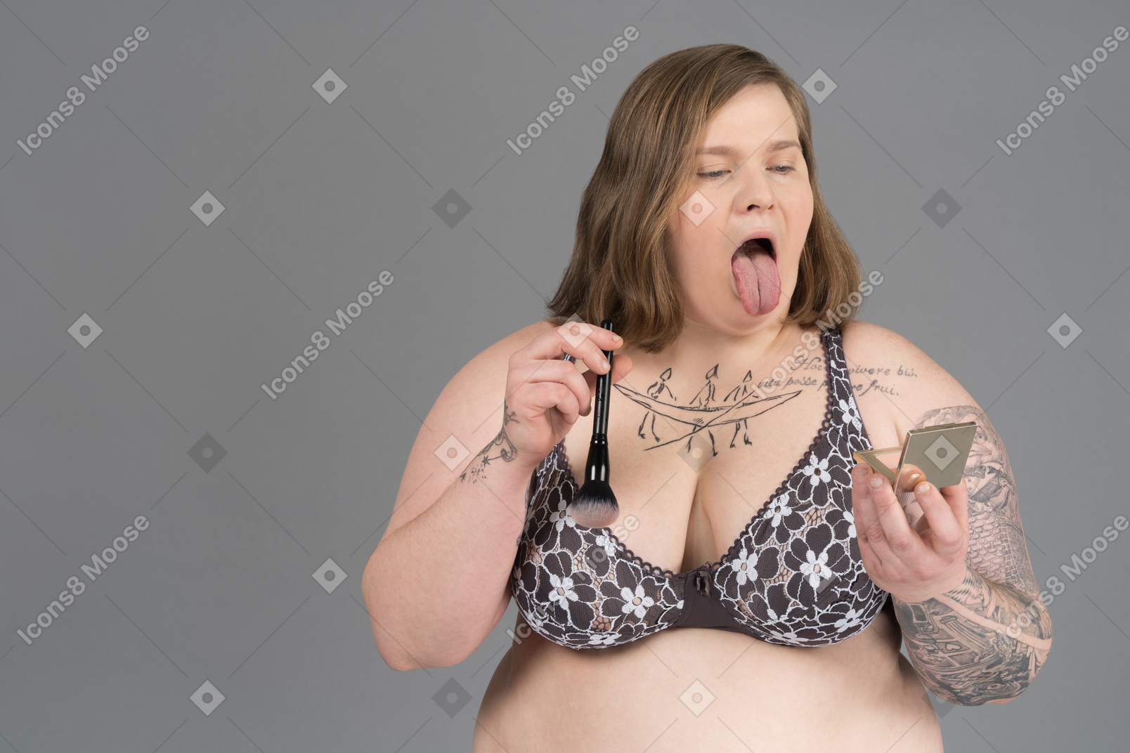 Plump woman showing tongue in hand mirror